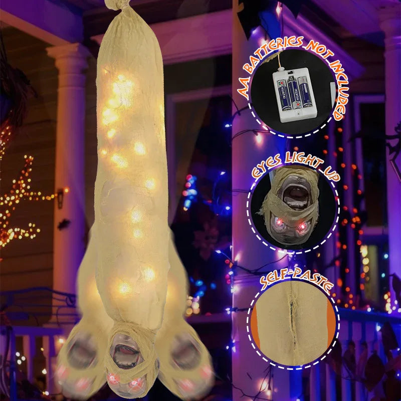 Hanging Halloween mummy prop with glowing LED lights, beige gauze material, and light-up red eyes