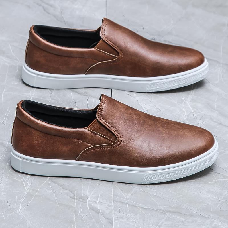 Brown faux leather slip-on sneakers with white rubber soles, casual streetwear style
