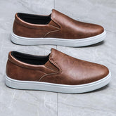 Brown faux leather slip-on sneakers with white rubber soles, casual streetwear style
