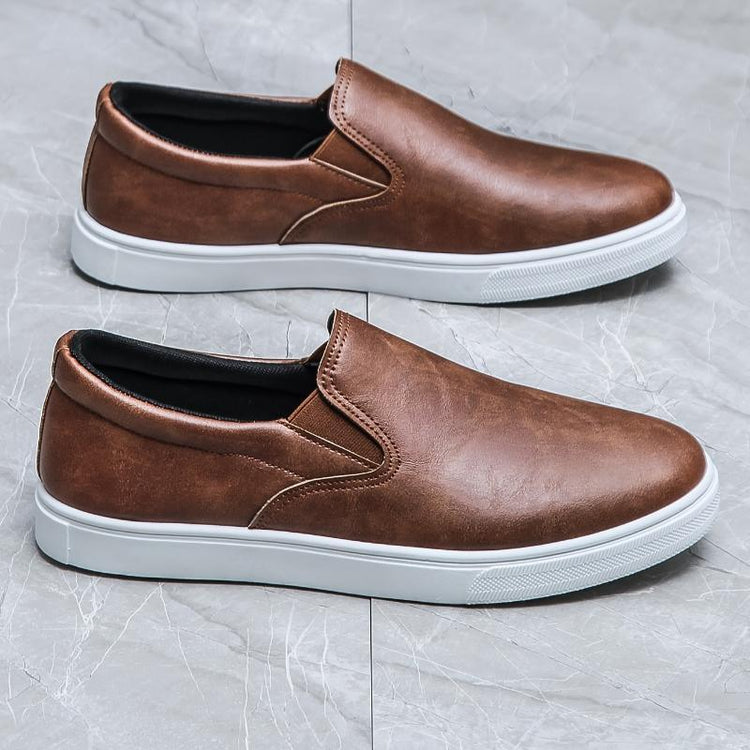 Brown faux leather slip-on sneakers with white rubber soles, casual streetwear style
