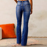 Back view of woman wearing blue denim flare jeans, high waist, classic fit