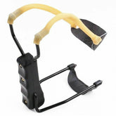 Black slingshot with yellow elastic bands and ergonomic grip, outdoor tool on white background