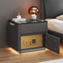 Modern black nightstand with glass top, LED lighting, built-in gold safe, and decorative lamp