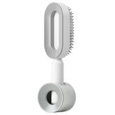 Modern white electric hair brush with sleek design and fine metal bristles