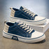Casual blue and beige canvas sneakers with white soles and lace-up design, modern streetwear style