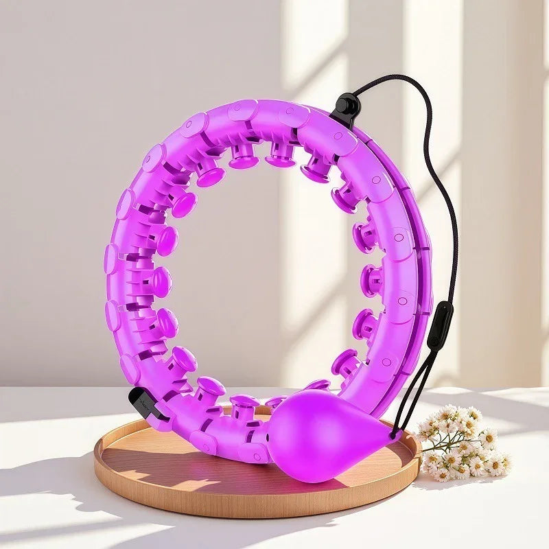 Purple adjustable plastic smart hula hoop with massage nodes and weighted ball on a table