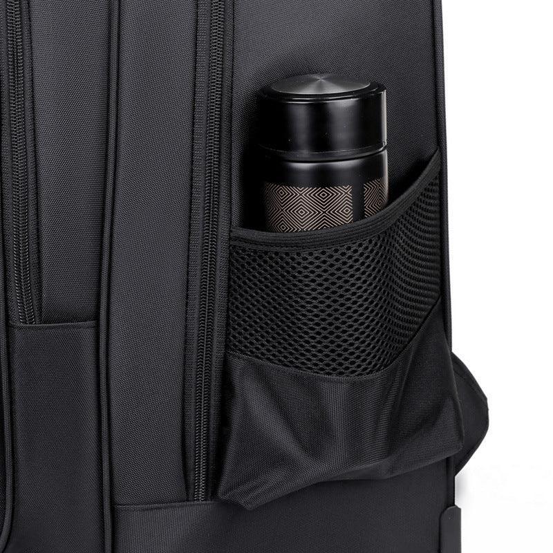 Black nylon backpack with side mesh pocket holding a water bottle