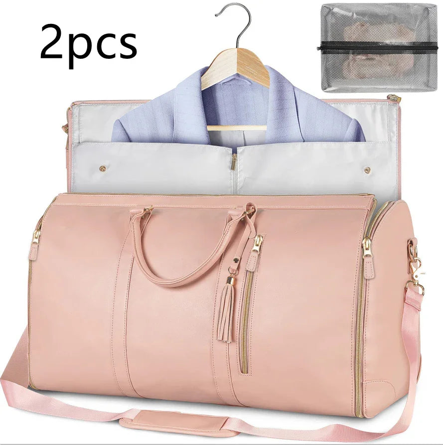 Light pink faux leather duffel bag with garment storage, gold zippers, and detachable strap