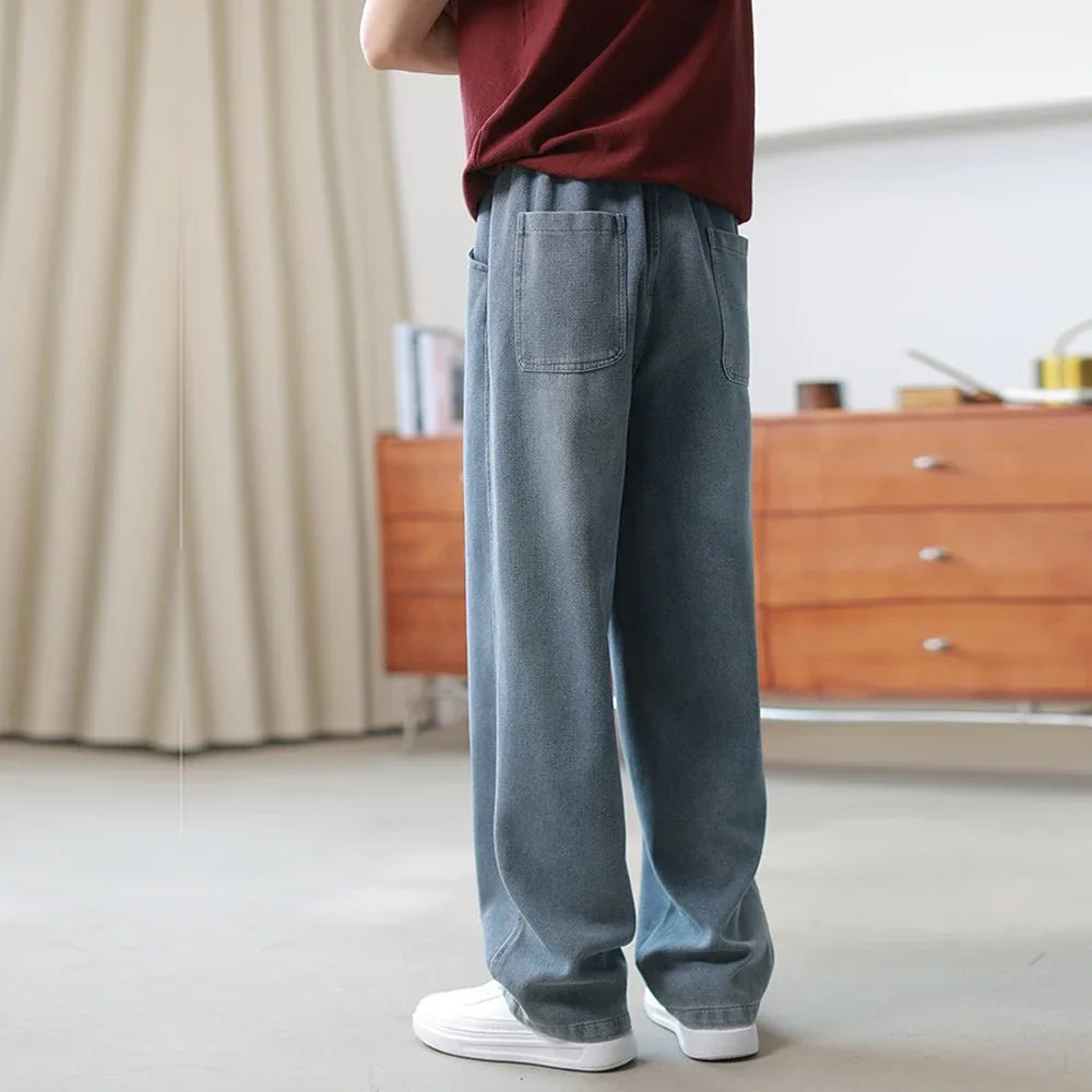 Loose fit light blue denim jeans with straight legs and elastic waistband, casual style