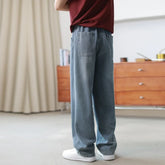 Loose fit light blue denim jeans with straight legs and elastic waistband, casual style