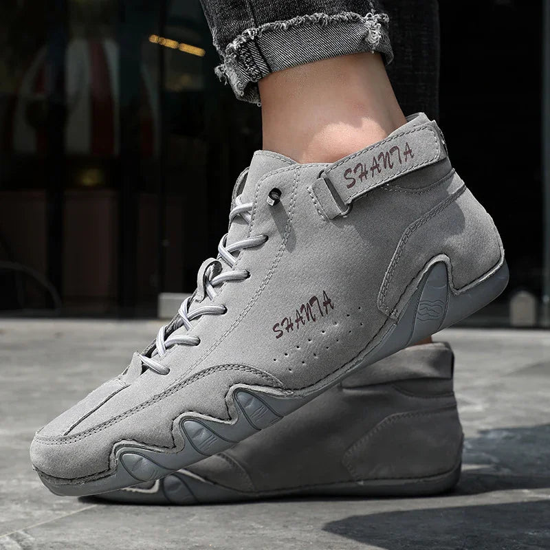 Gray suede high-top sneakers with lace-up design, rugged sole, and athletic fit