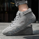 Gray suede high-top sneakers with lace-up design, rugged sole, and athletic fit