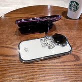 Clear and white astronaut phone case with raised 3D design on wooden table