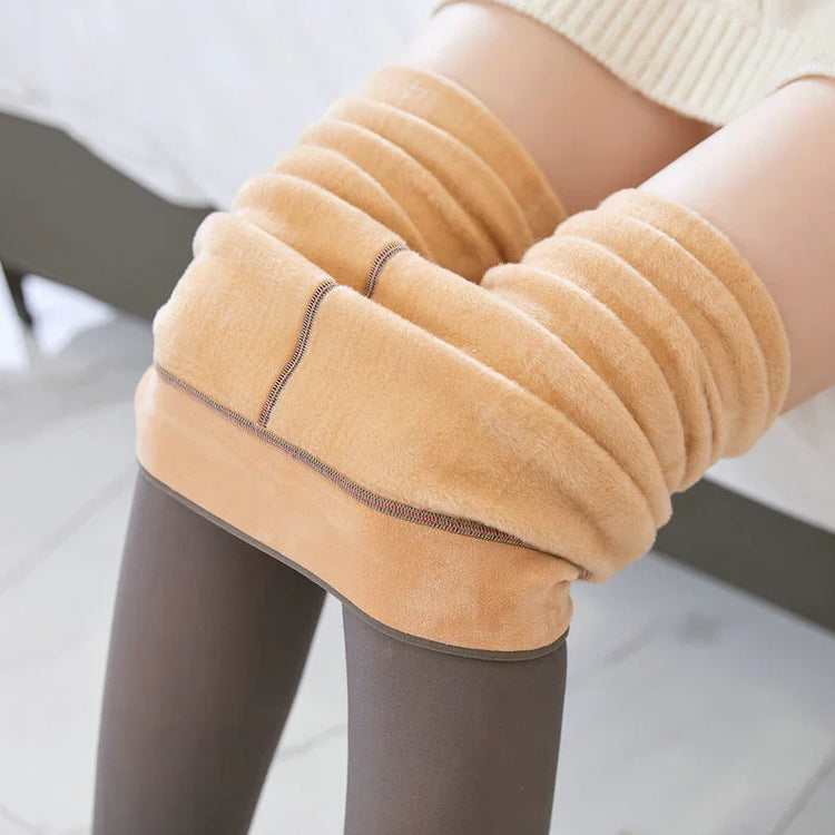 Close-up of beige fleece-lined leggings, soft material, slim fit, cozy winter style.