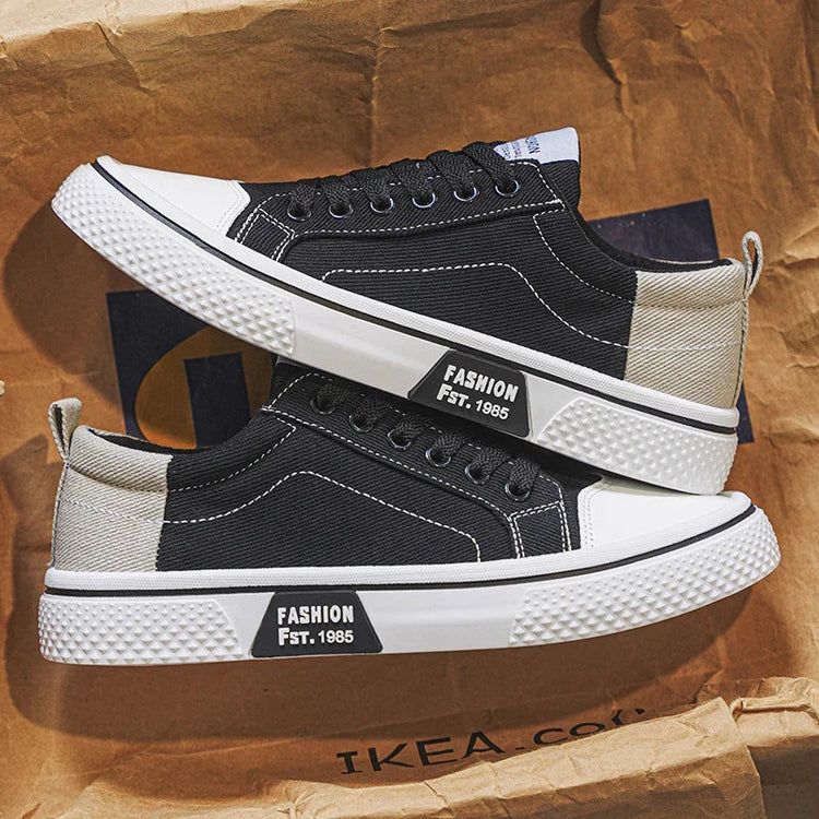 Black and beige canvas sneakers with white rubber soles, low-top streetwear style, classic lace-up fit.