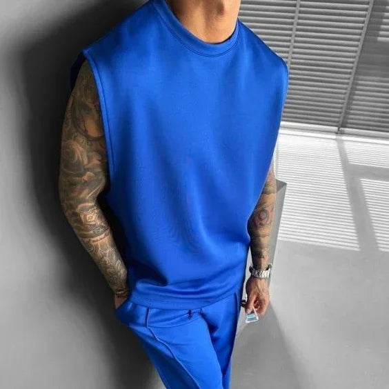 Man wearing loose fit sleeveless royal blue top and matching blue pants, soft fabric