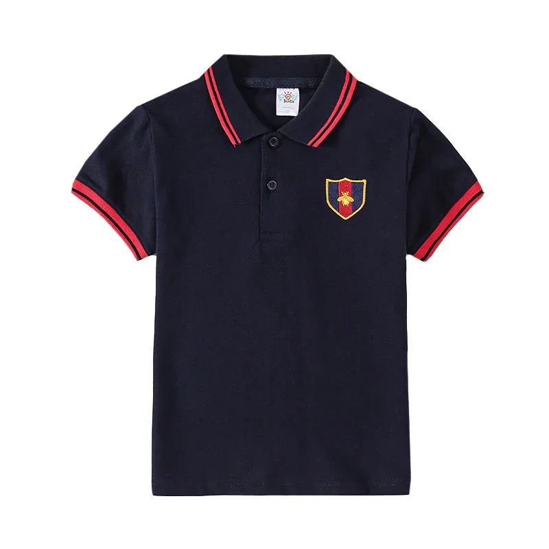 Navy blue short-sleeve polo shirt with red trim, embroidered crest, cotton material, regular fit