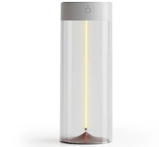 Minimalist cylindrical glass table lamp with warm vertical LED light and silver top.