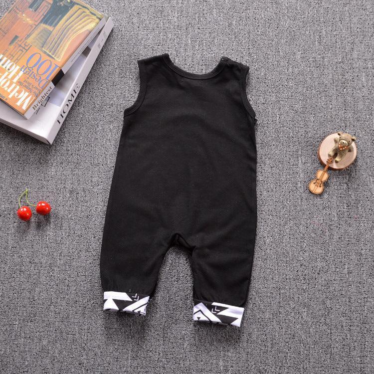 Sleeveless black romper with white geometric cuffs, soft cotton, relaxed fit, laid on grey surface