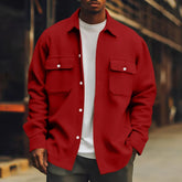 Man wearing oversized red button-up shirt jacket with chest pockets, white t-shirt, streetwear style