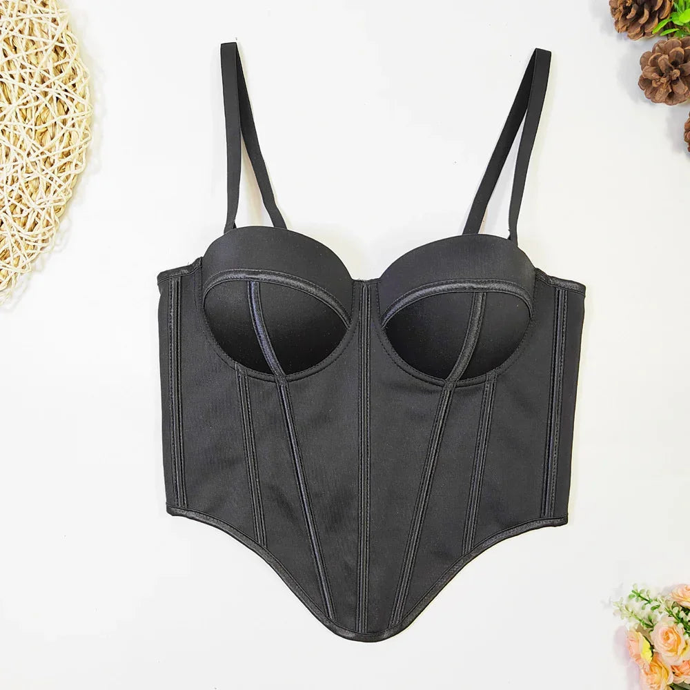 Black bustier top with structured cups, adjustable straps, and fitted waist, laid flat.