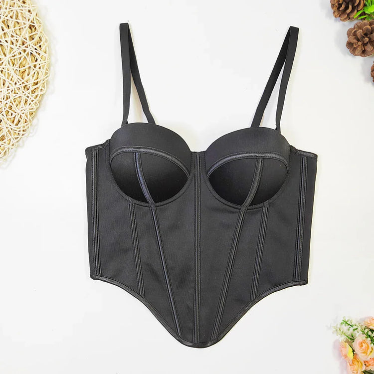 Black bustier top with structured cups, adjustable straps, and fitted waist, laid flat.