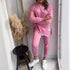 Woman wearing a pink relaxed fit cotton sweatshirt and matching jogger pants set
