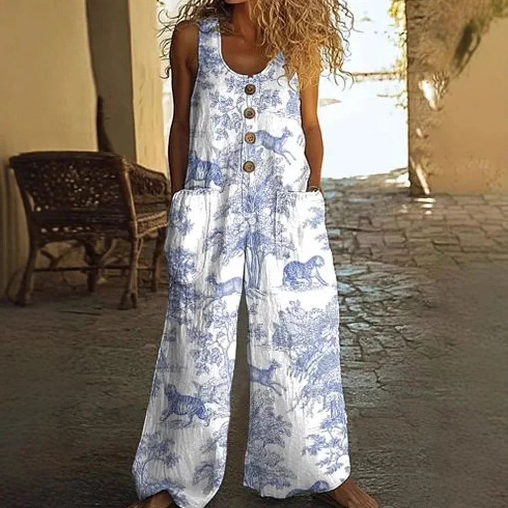 Woman wearing loose-fit white and blue sleeveless jumpsuit with animal print and front buttons.