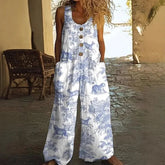 Woman wearing loose-fit white and blue sleeveless jumpsuit with animal print and front buttons.
