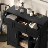 Modern black wooden storage cabinet with open drawers, books, and decorative items on top