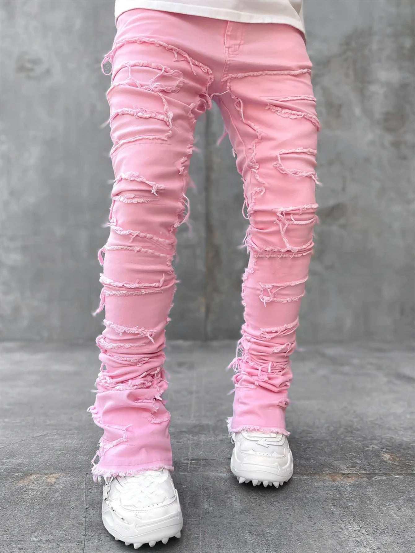 Pink distressed skinny jeans with frayed rips, streetwear style, paired with white sneakers