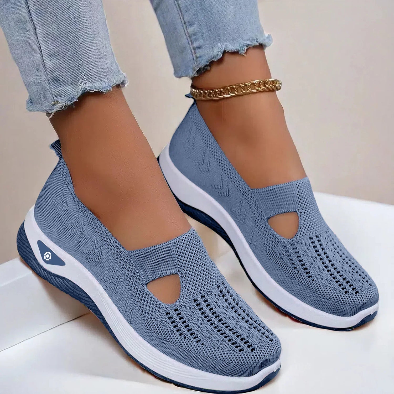 Light blue knit slip-on sneakers with breathable mesh, white soles, and relaxed fit
