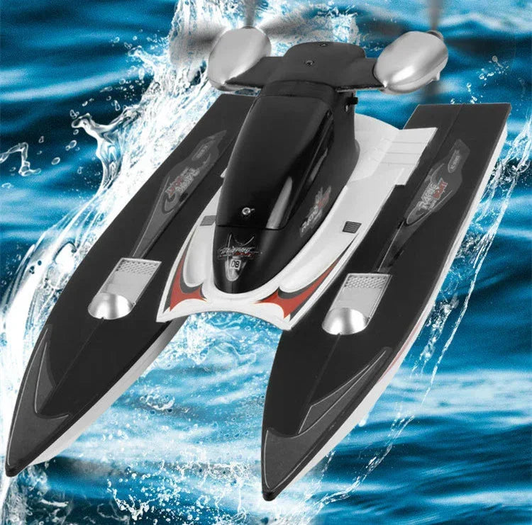 Black and white remote control racing boat with red accents on water, modern aerodynamic design