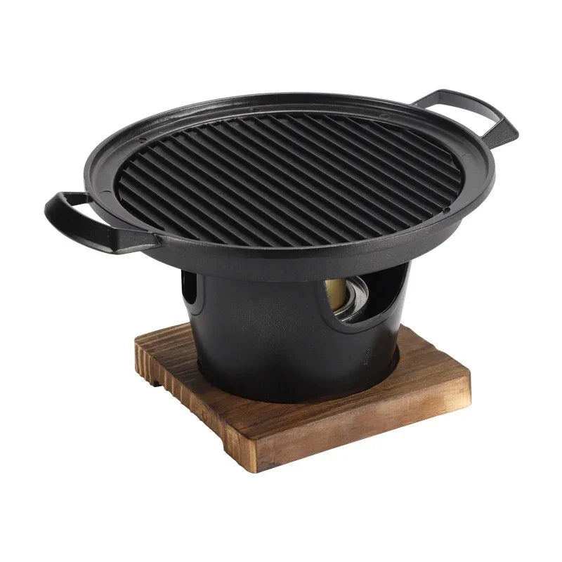 Round black cast iron tabletop grill with wooden base, modern minimalist design