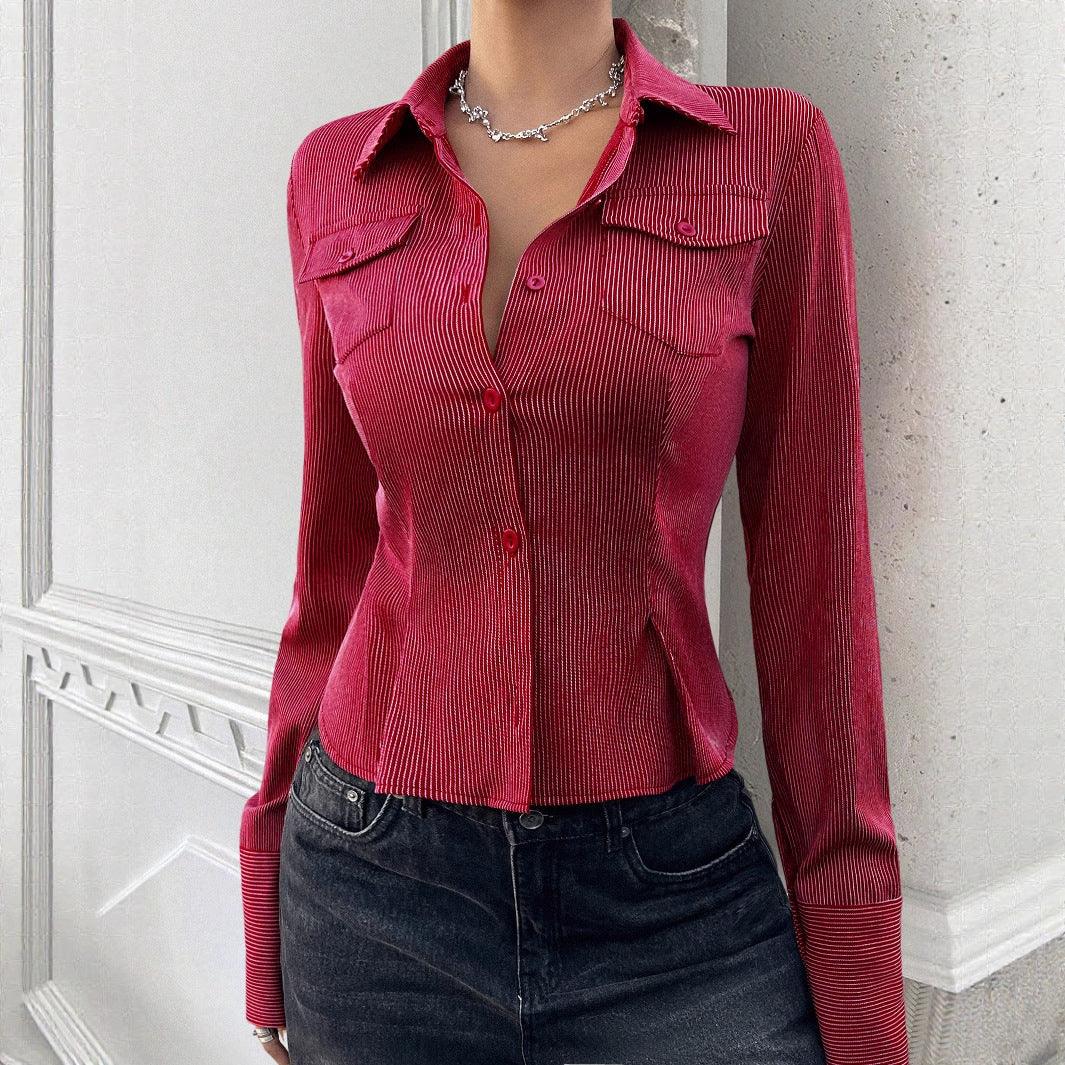 Fitted red pinstripe button-up shirt with long sleeves and collared neckline, paired with black jeans.