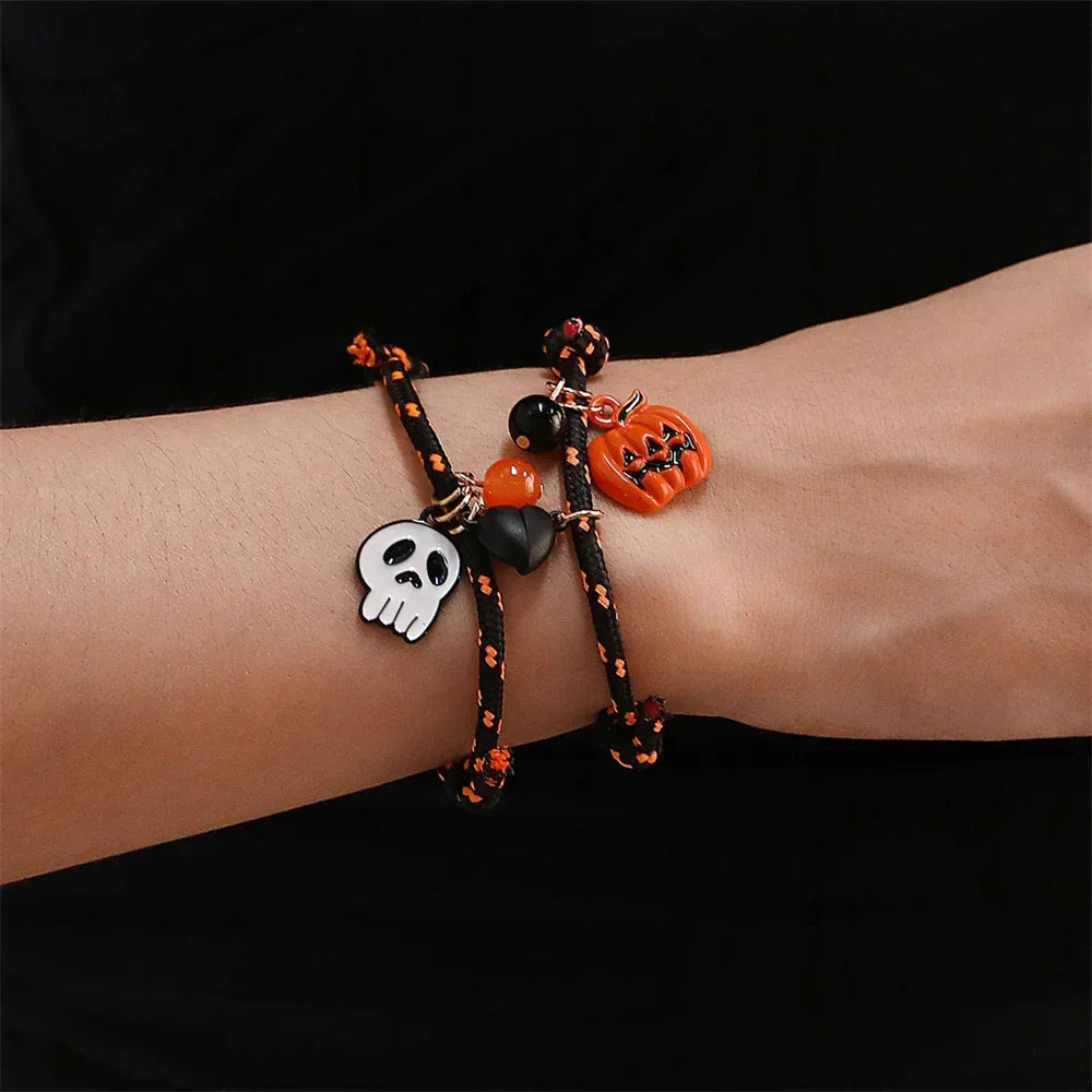 Black and orange cord bracelets with skull, pumpkin, and bead charms, Halloween style.