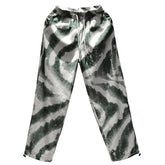 Loose fit green and white abstract print jogger pants with elastic waistband, streetwear style