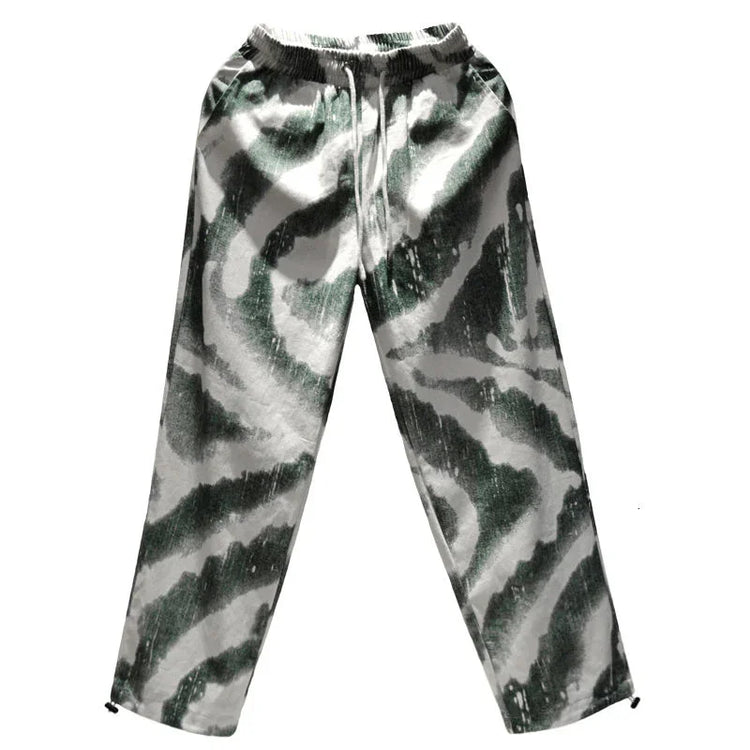 Loose fit green and white abstract print jogger pants with elastic waistband, streetwear style
