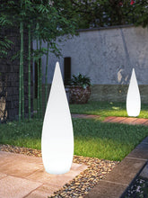 Modern white cone LED garden lights on stone path in outdoor setting, surrounded by greenery