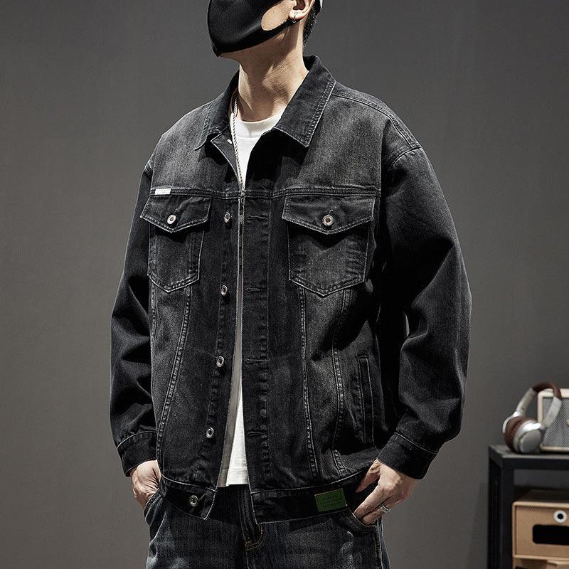Oversized black denim jacket with button front, chest pockets, and relaxed fit streetwear style