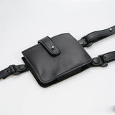 Black faux leather utility belt bag with adjustable straps and snap closure, modern streetwear accessory