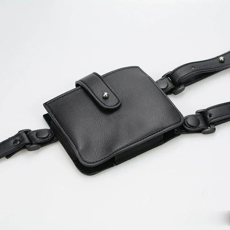 Black faux leather utility belt bag with adjustable straps and snap closure, modern streetwear accessory