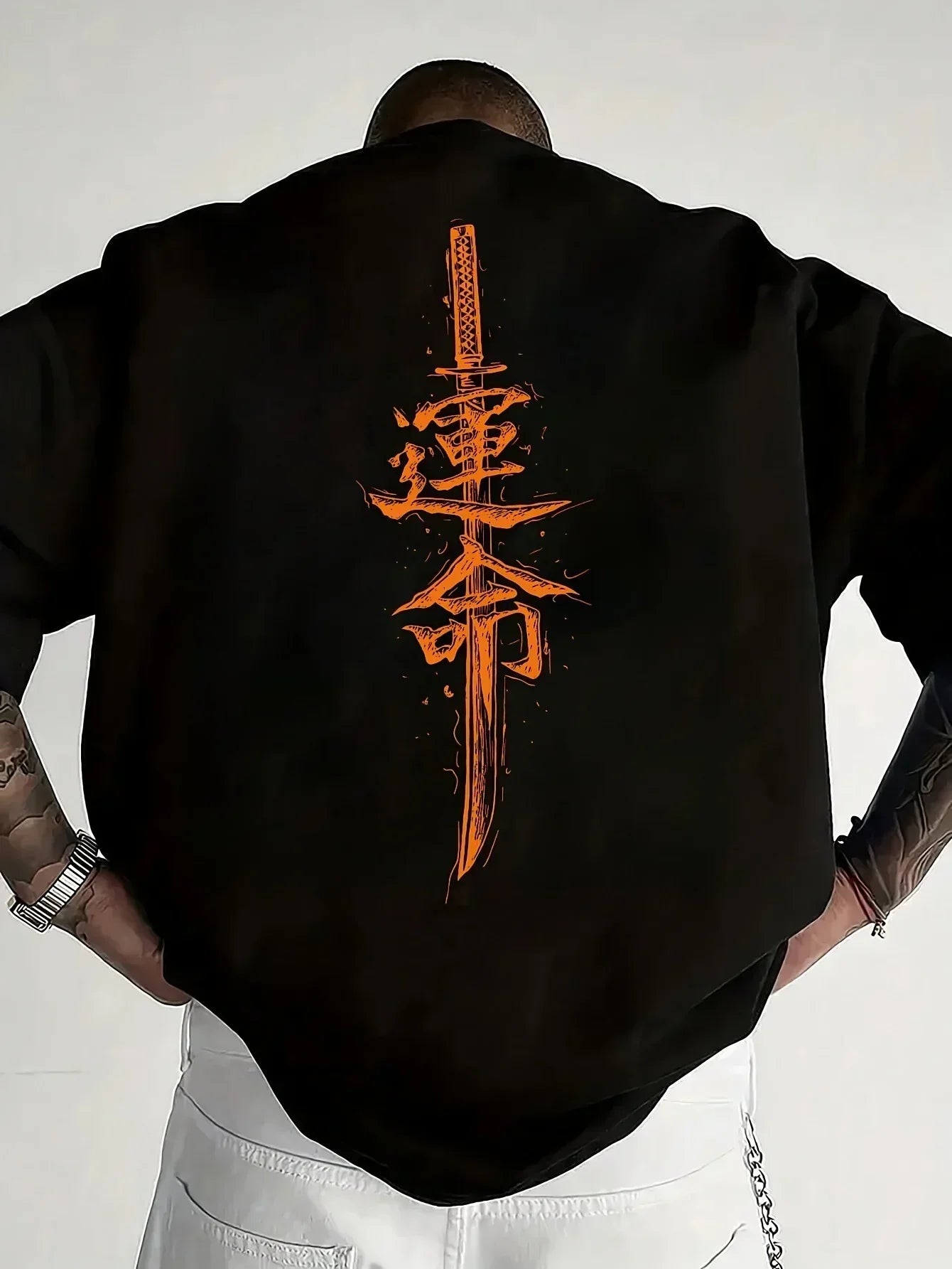 Oversized black streetwear shirt with bold orange sword and kanji graphic on the back