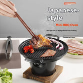 Mini tabletop BBQ grill with steaks, sliced red chili, and onions being cooked, modern indoor setting.