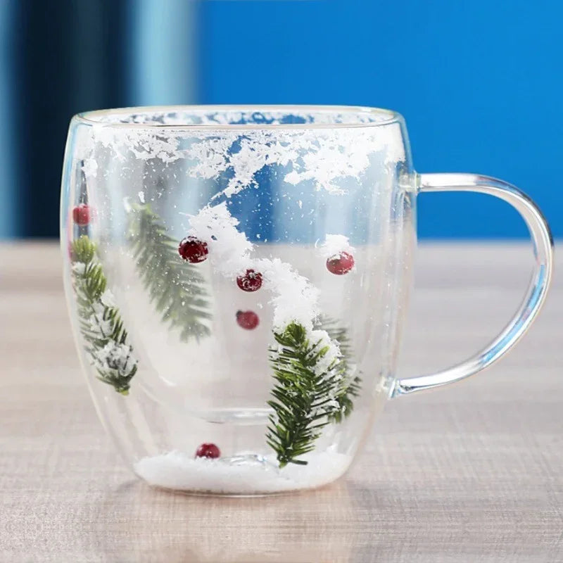 Clear glass mug with festive pine branches, red berries, and snowflake decorations.