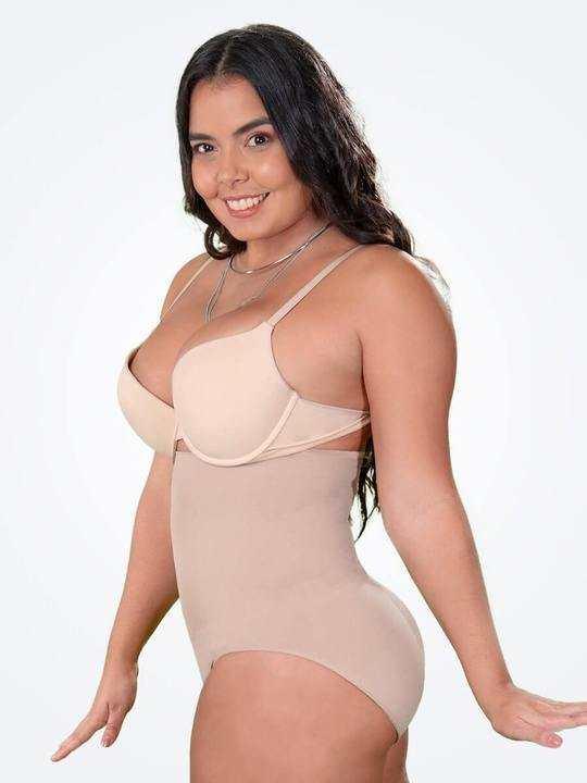 Woman modeling beige high-waisted shapewear bodysuit with adjustable straps, slim fit