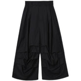 Wide-leg black pants with draped details, loose fit, futuristic streetwear style