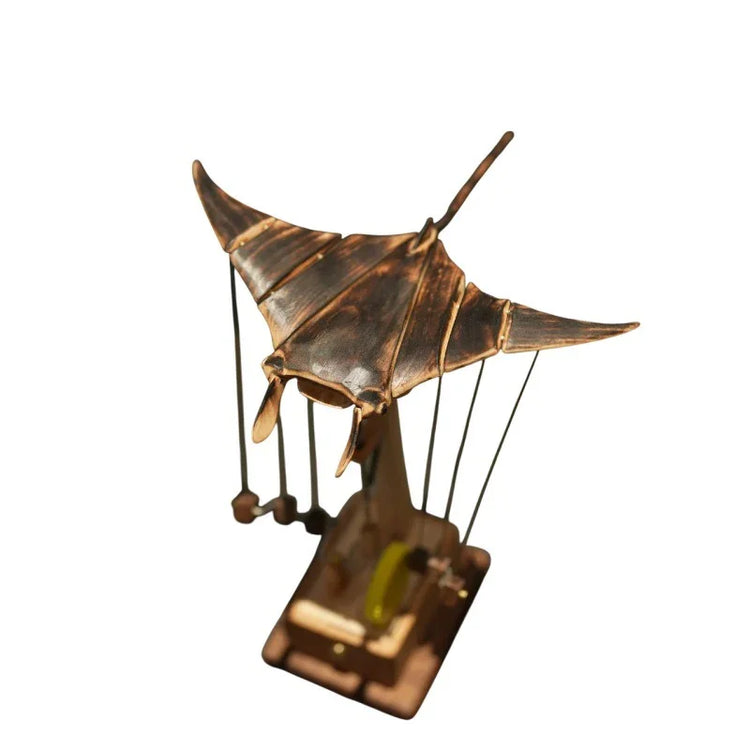Bronze-toned metal manta ray sculpture with mechanical steampunk accents