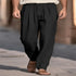 Man wearing black pleated wide-leg trousers with relaxed fit and lightweight fabric