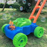 Colorful plastic bubble lawn mower toy in blue, green and orange on grass outdoors